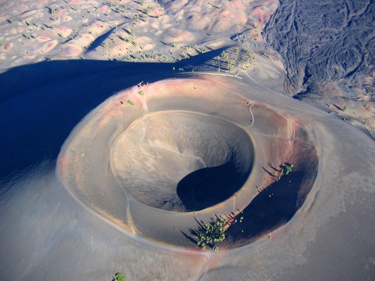 aerial view of a cinder cone and volcanic landscape