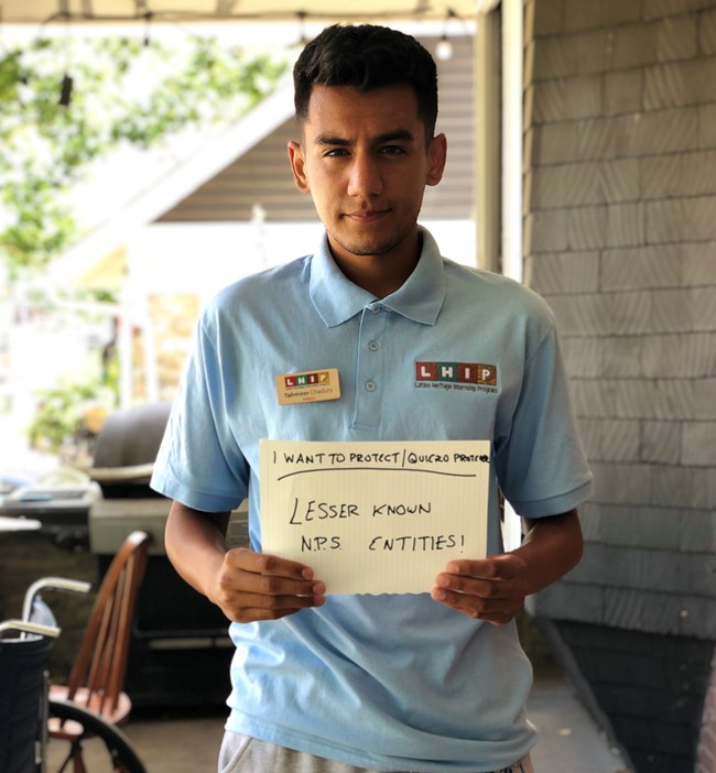 T Chadury Latino Conservation Week 2020, "'I want to protect..." Man holding a sign on a porch