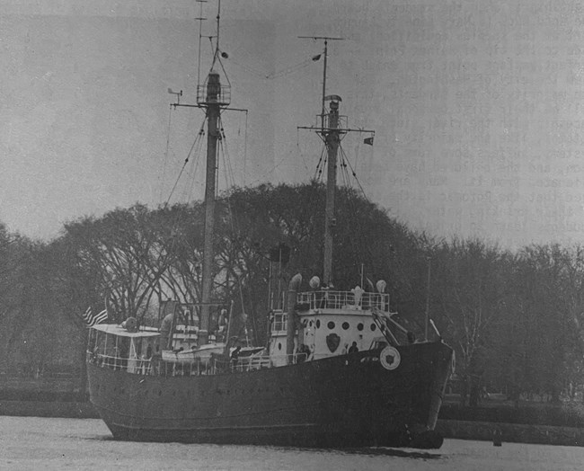 Chesapeake Ship with and NPS arrowhead on it floating in a channel