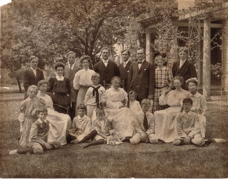 a group of adults and children posing for a picture