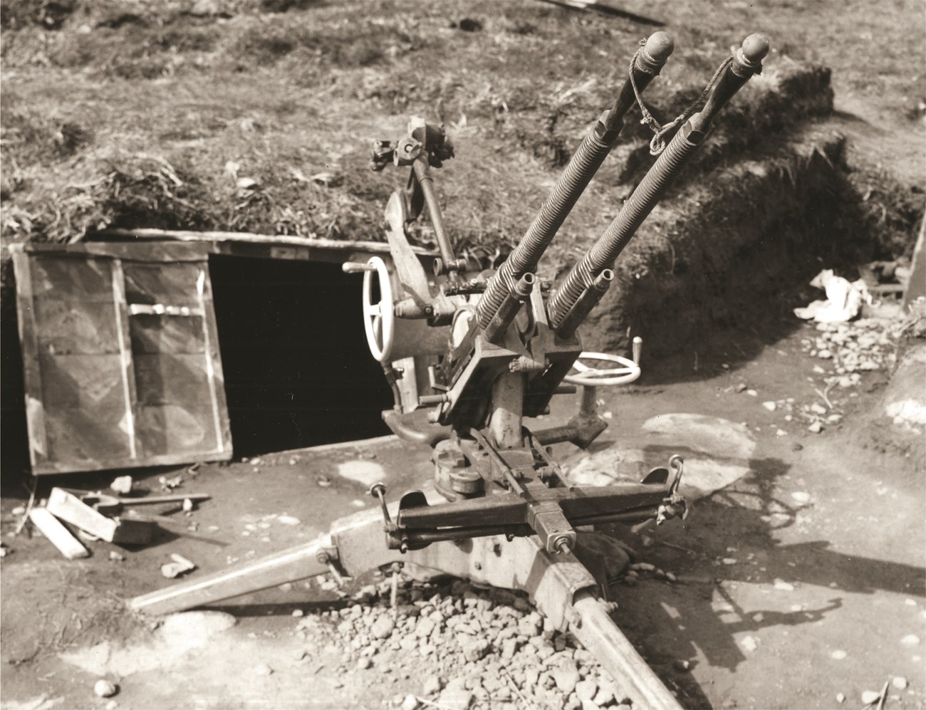 13.2mm Anti-Aircraft Gun on Kiska Black and white photo of twin-mounted anti-aircraft gun.