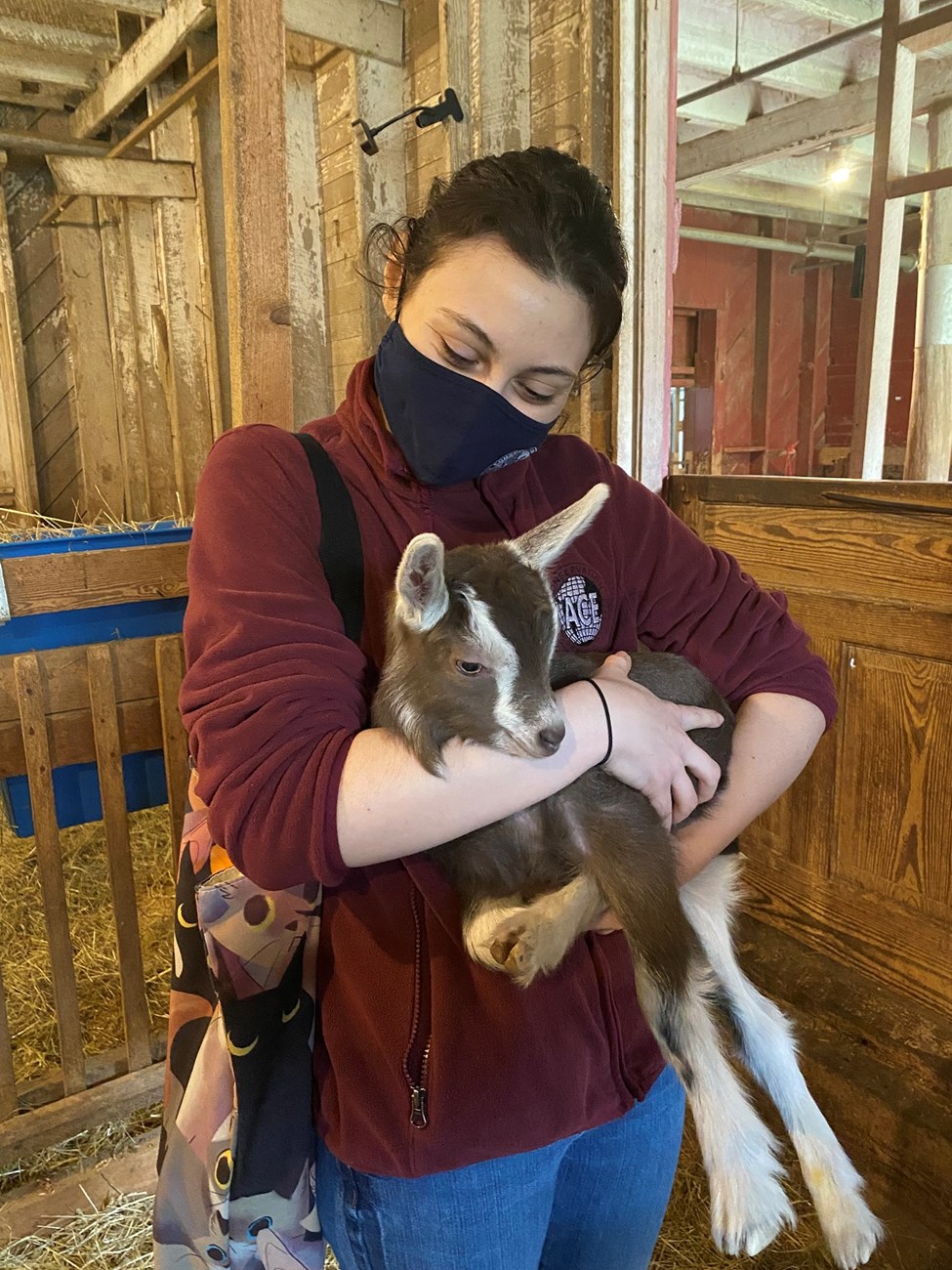 Madi holding one of the first baby goats of the season at CARL