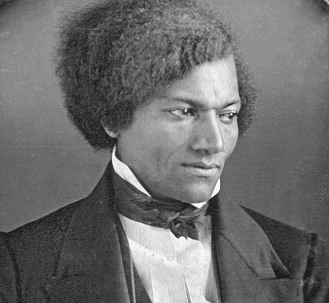 Frederick Douglass, 1840s A Black man wearing a suit jacket and a collared shirt.