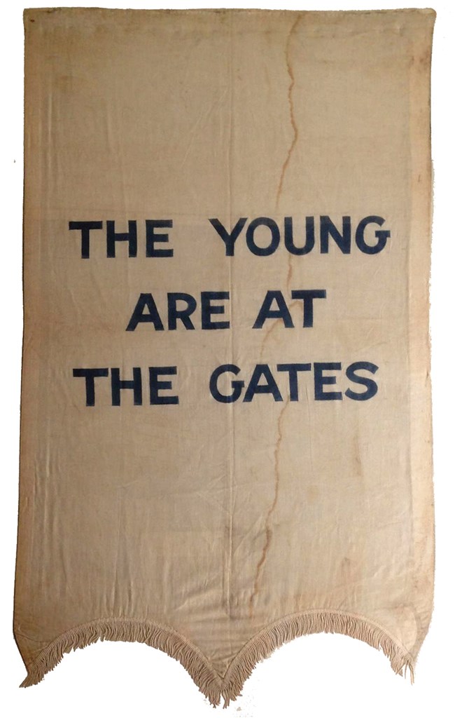 Banner used by the National Women's Party during pickets, 1913–20. silk banner with the words "The Young Are At the Gates" in capital letters