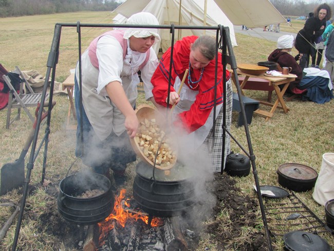 Making stew during a volunteer living history event.