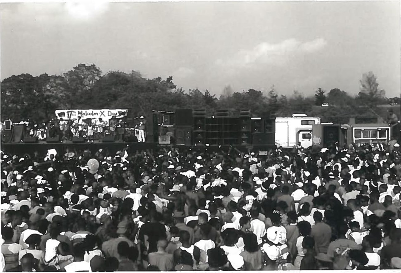 Many people gather around the stage at Malcolm X Day