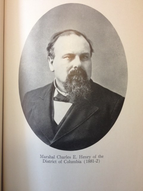 marshal-charles-e-henry man in a suit has a long brown beard