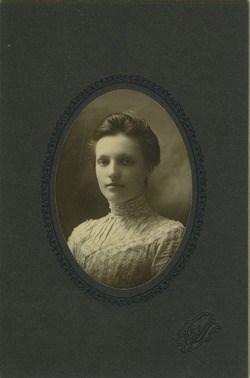 Young Mary Rolfe Studio portrait of a young Mary Rolfe wearing a high-necked dress.