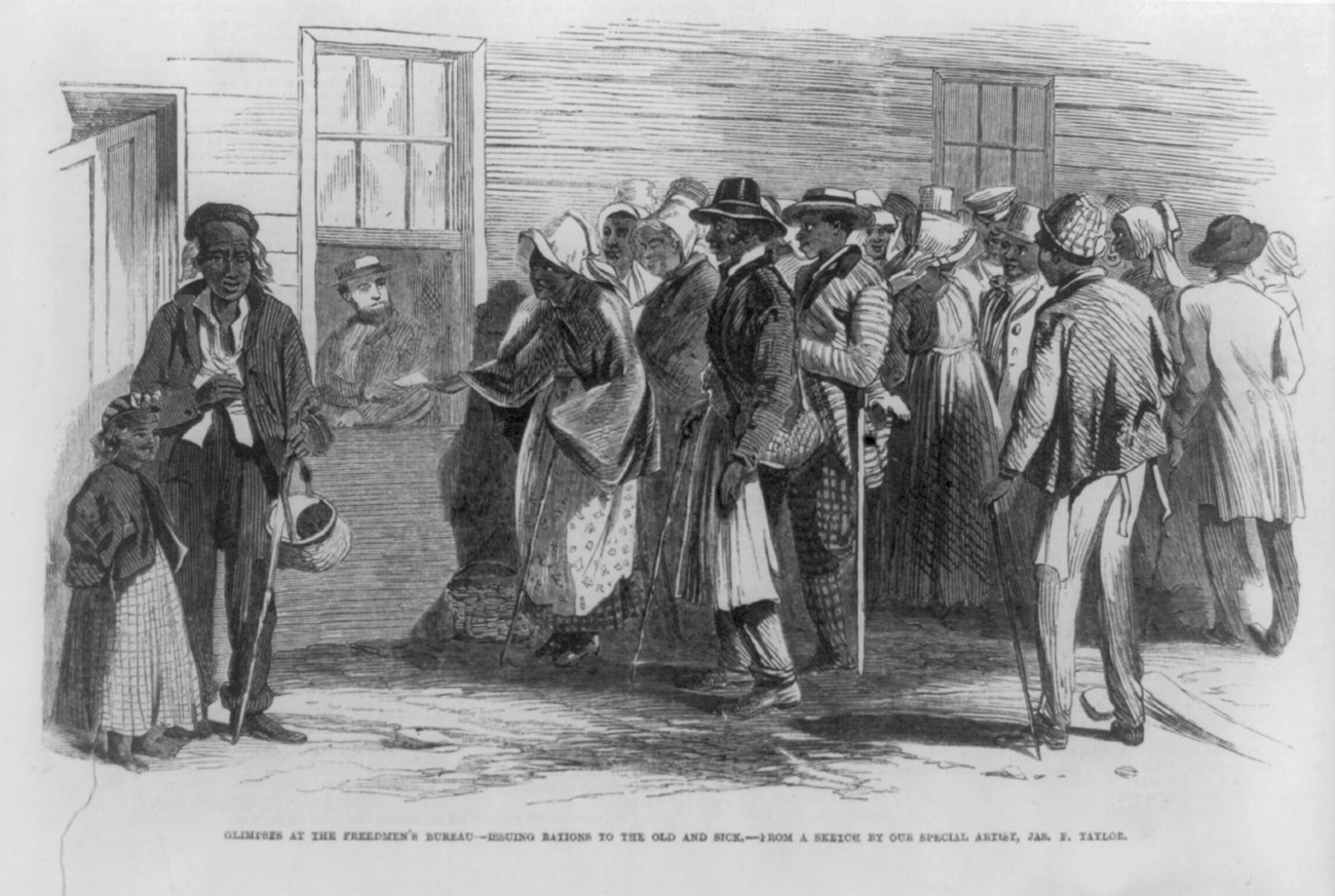 A group of people stand in line waiting for rations from a man in a building.