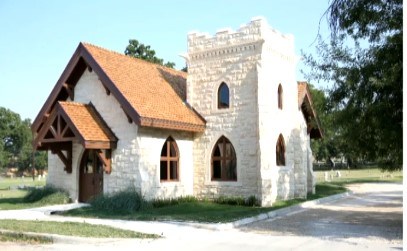 Oakwood Chapel, Austin, Texas A small stone chapel, painted white, with a wooden roof.