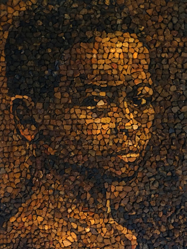 Brick mosaic of a young enslaved boy constructed out of brick pieces