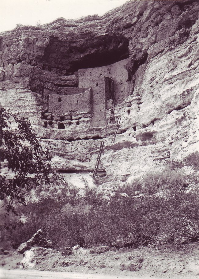 Stone building built into the side of a cliff