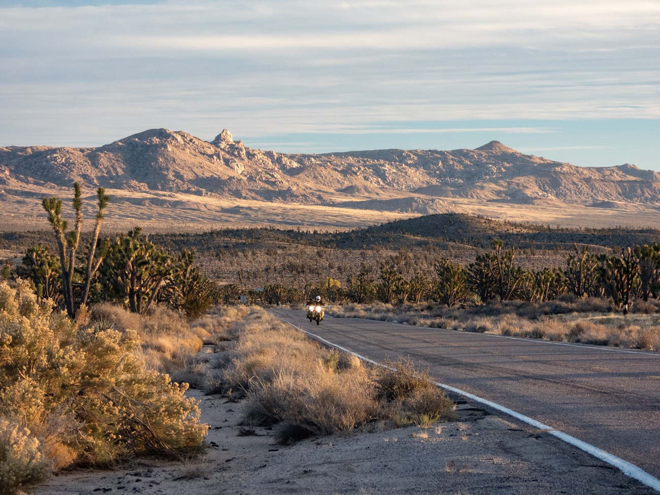 lt= two motorcyclists on a desert road