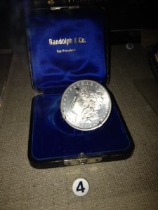 mollies-coin1 a silver coin displayed in a blue velvet case the size of a ring box