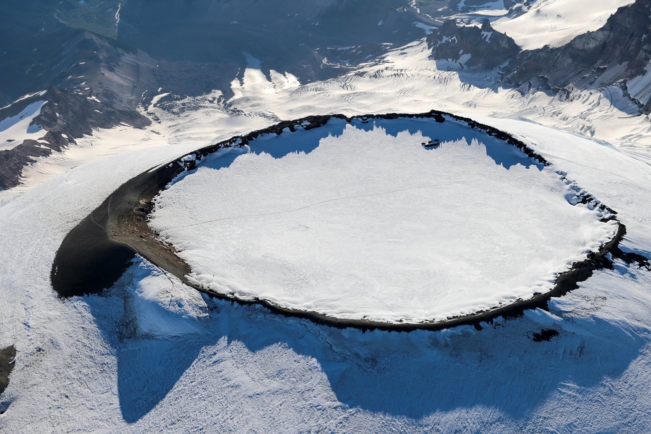 aerial view of a snow covered volcanic crater