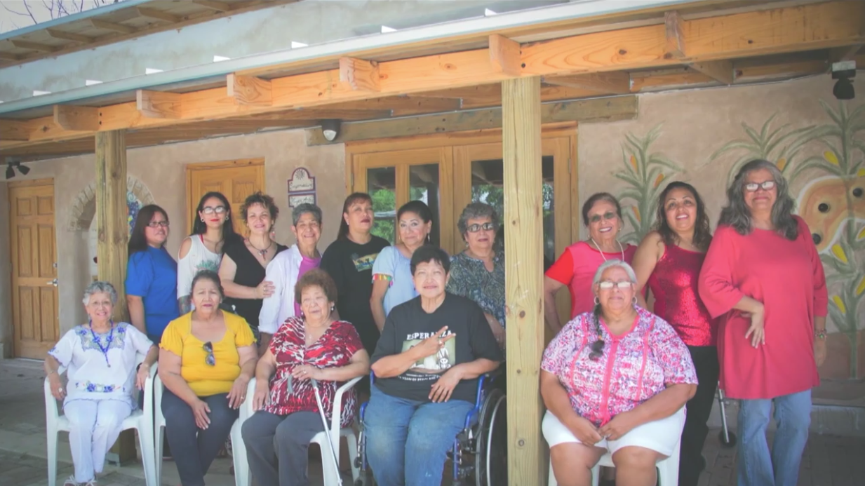 Several women in front of an adobe building at Rinconito.