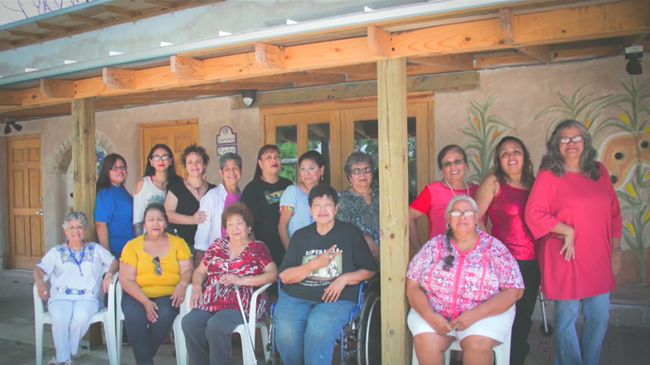 MujerArtes Clay Cooperative Several women in front of an adobe building at Rinconito.