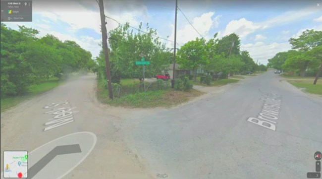 A historic street intersection in Joppa A fork in the road splits in two long, straight and narrow streets, lined by historic homes and vegetation.