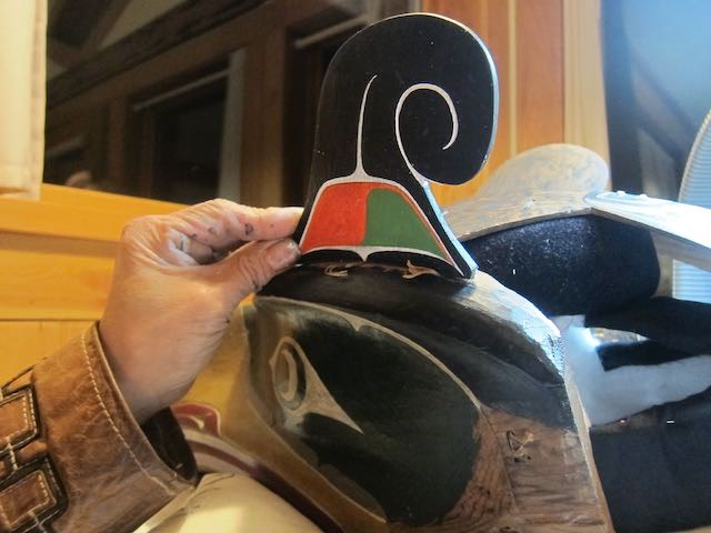 Late Kwakwaka'wakw artist and hereditary chief, ‘Walas Gwa’yam (Beau Dick) checking the fit of a newly carved replacement piece on the Thunderbird Headdress. Beau Dick checks the fit of a newly carved replacement piece on the Thunderbird Headdress.