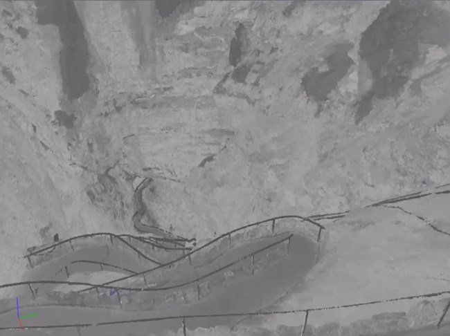 Still image of fly through shown during the presentation. Blue areas are shadows – areas where there is no data. Photo showing the trail winding steeply into the distance of the vast caverns.