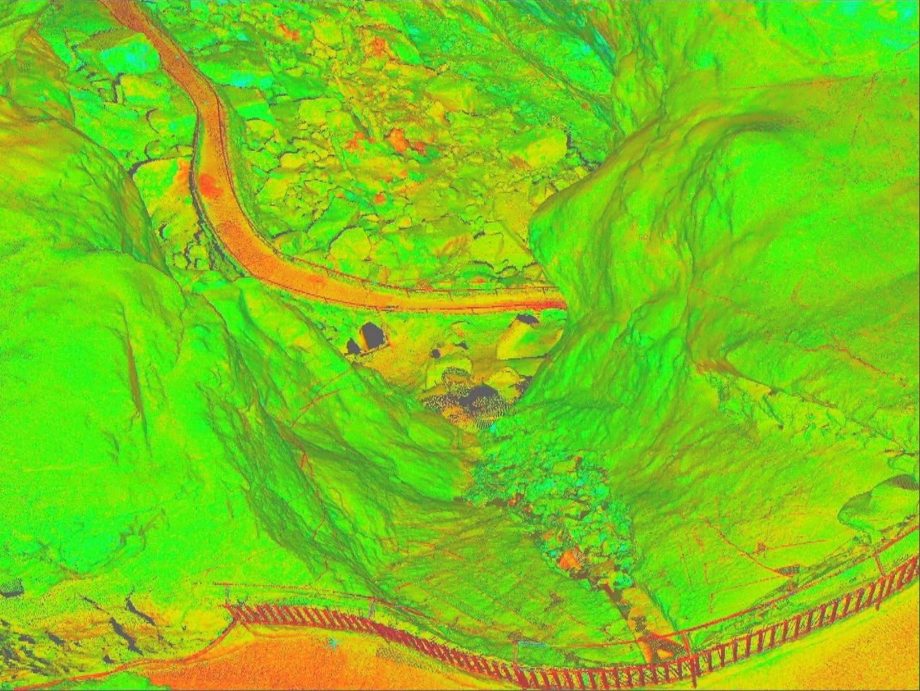 The delivered data from this project has been maintained as a point cloud, billions of XYZ coordinates, as well as converted into a voxel-based data. Voxels are three-dimensional pixels, cubes, like seen in Minecraft. A false color render of point cloud data showing trails through the caverns.