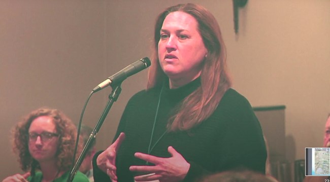 Julie McGilvrey asks a question during the Q&A. Audience members ask questions of presenters and panelists.