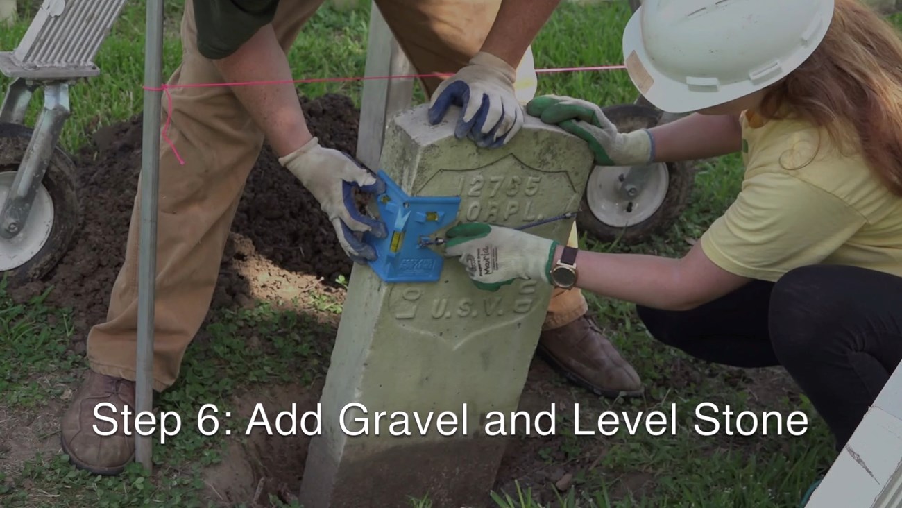 Use a post level to monitor that the stone stays plumb and level while gravel is placed around it.