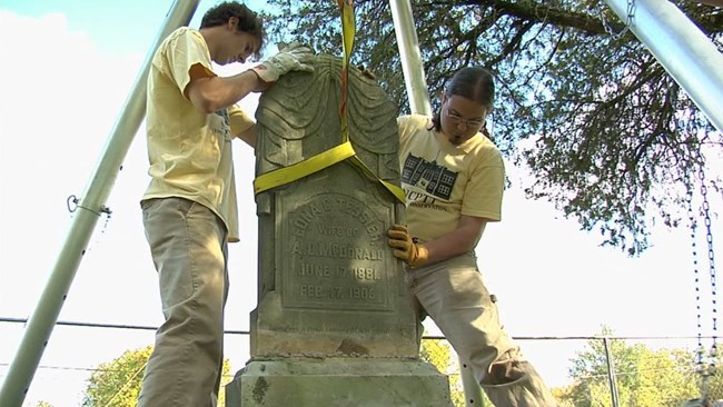 Place the headstone back on the base, making sure to guide the stone slowly and carefully. It is important to have enough help to safely lift and control the stone while it is maneuvered back onto the base.