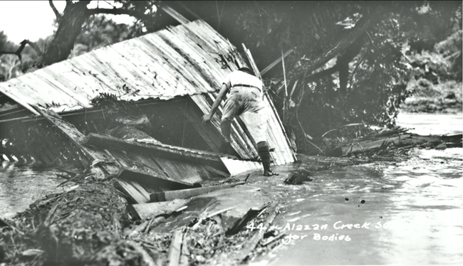 The Flood of 1921 killed 49 residents in Westside. A man searches for bodies in the debris of homes along Alazan Creek.