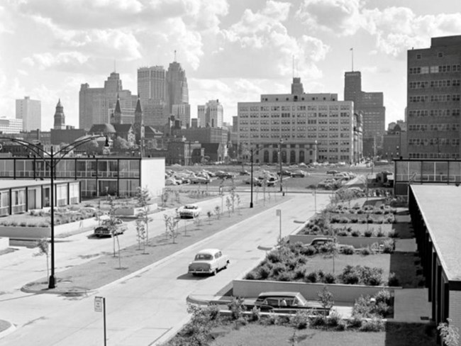 A black and white photograph taken of the urban landscape and concentrating housing beside the park.