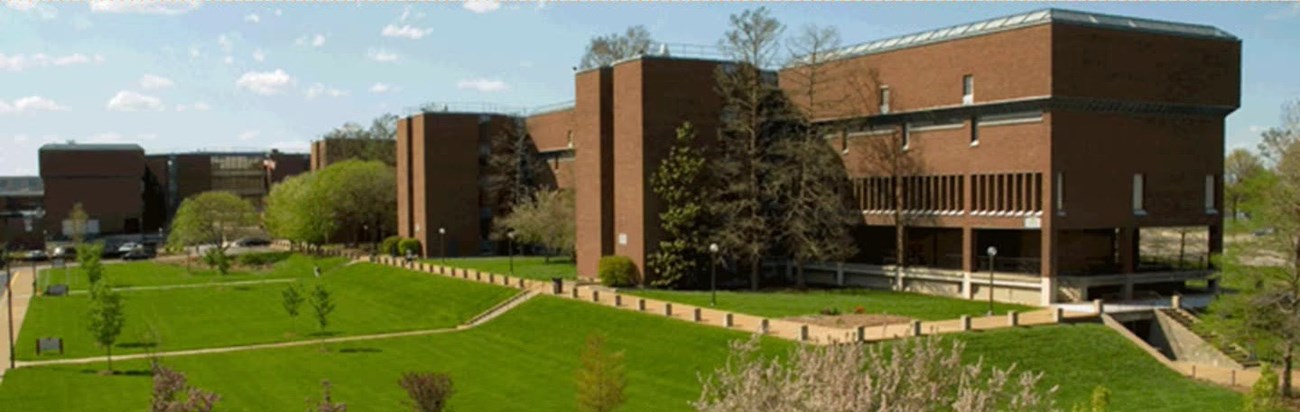 A large multistory multi-wing brick building.