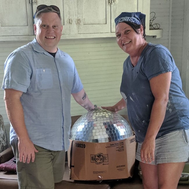 Josh Burford and donor with the first disco ball from a gay bar in Tuscaloosa. Josh Burford and donor with the first disco ball from a gay bar in Tuscaloosa