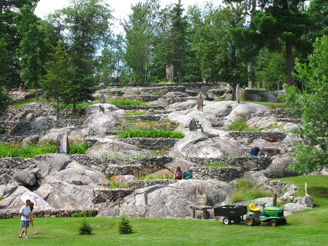 View of raised flower beds and stone sculptures on the granite outcropped hillside