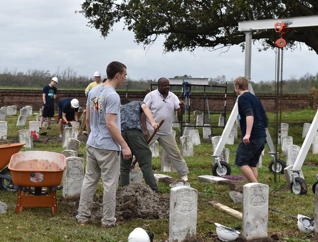 Teddy Pierre instructing volunteers at a HOPE Project in Chalmette National Cemetery.