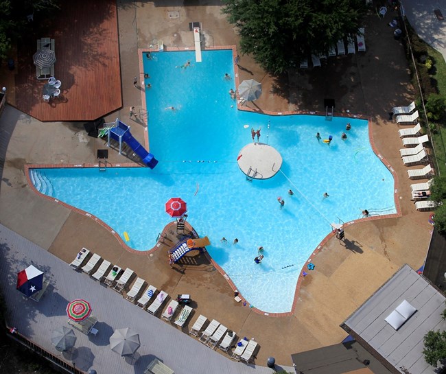 Birdseye view of a large swimming pool shaped like the state of Texas.