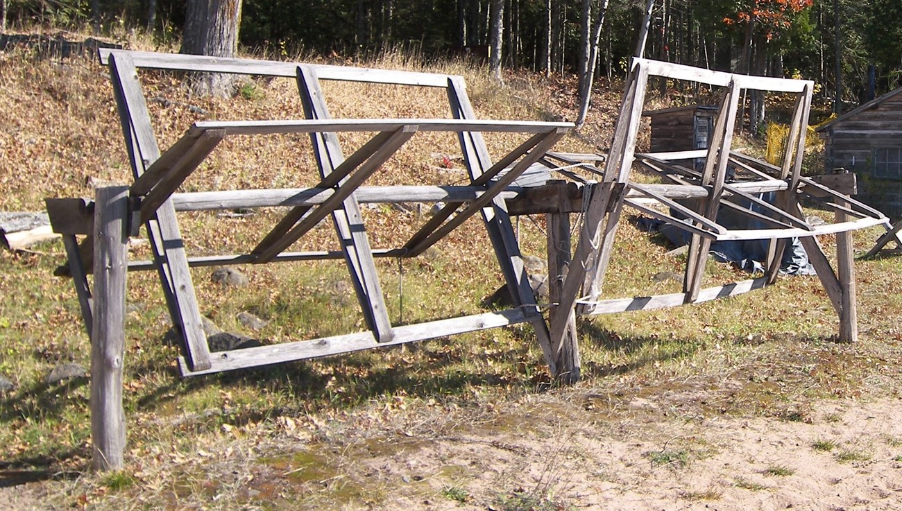 Historic wooden frames crossed at right angles (2 sets) that turn to wind nets for drying in the sun.