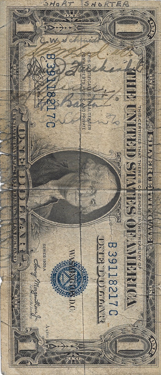 dollar bill with autographs on it