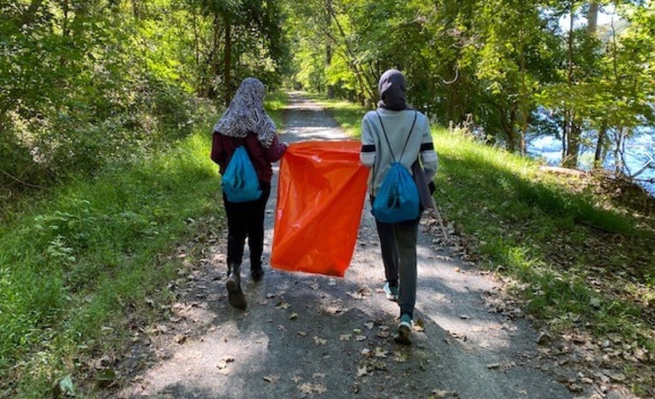 Two volunteers pick up trash along the river as part of the 3rd Annual Delaware River Cleanup on September 19, 2020. Image credit: Delaware River Greenway Partnership website.