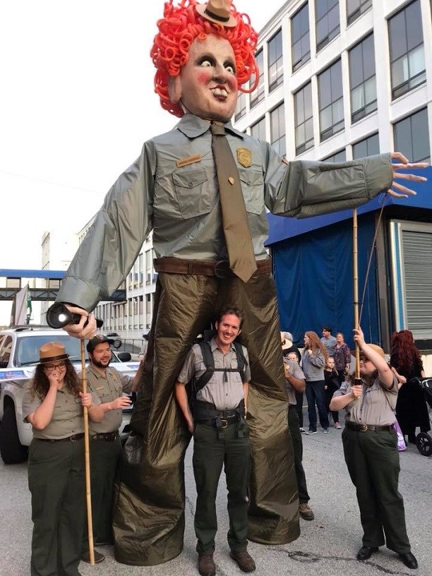 Park rangers with a giant puppet of a Bette Midler puppet in a ranger uniform