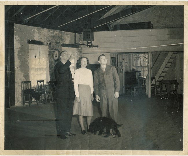 A man, a woman and a minister standing inside a building