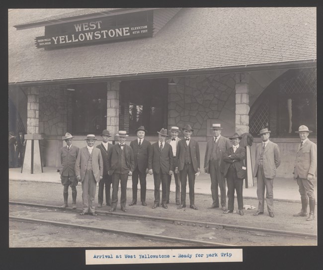 West Yellowstone A dozen men stand on train tracks posing for a photo
