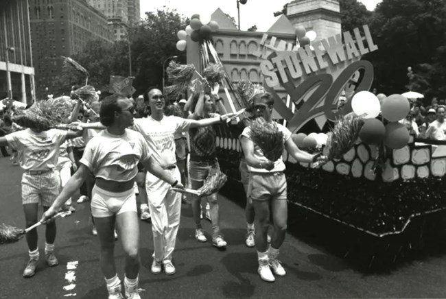 Marchers cheer Stonewall 20, at the 20th annual New York City Pride Parade, in 1990. A float reads, "Stonewall 20."