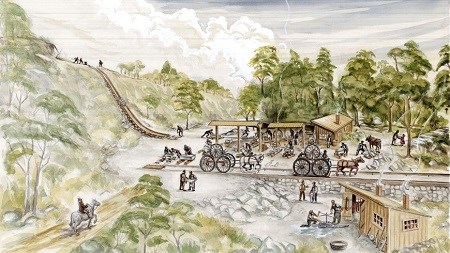 landscape of a quarry with a few work sheds and a track with horse-drawn carriages