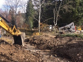 Building equipment recontouring the streambanks