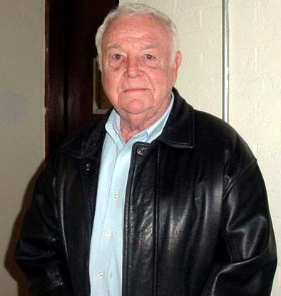 an older Caucasian man poses for a photo