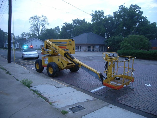 Cherry picker with mounted equipment on Front Street, Natchitoches, LA.