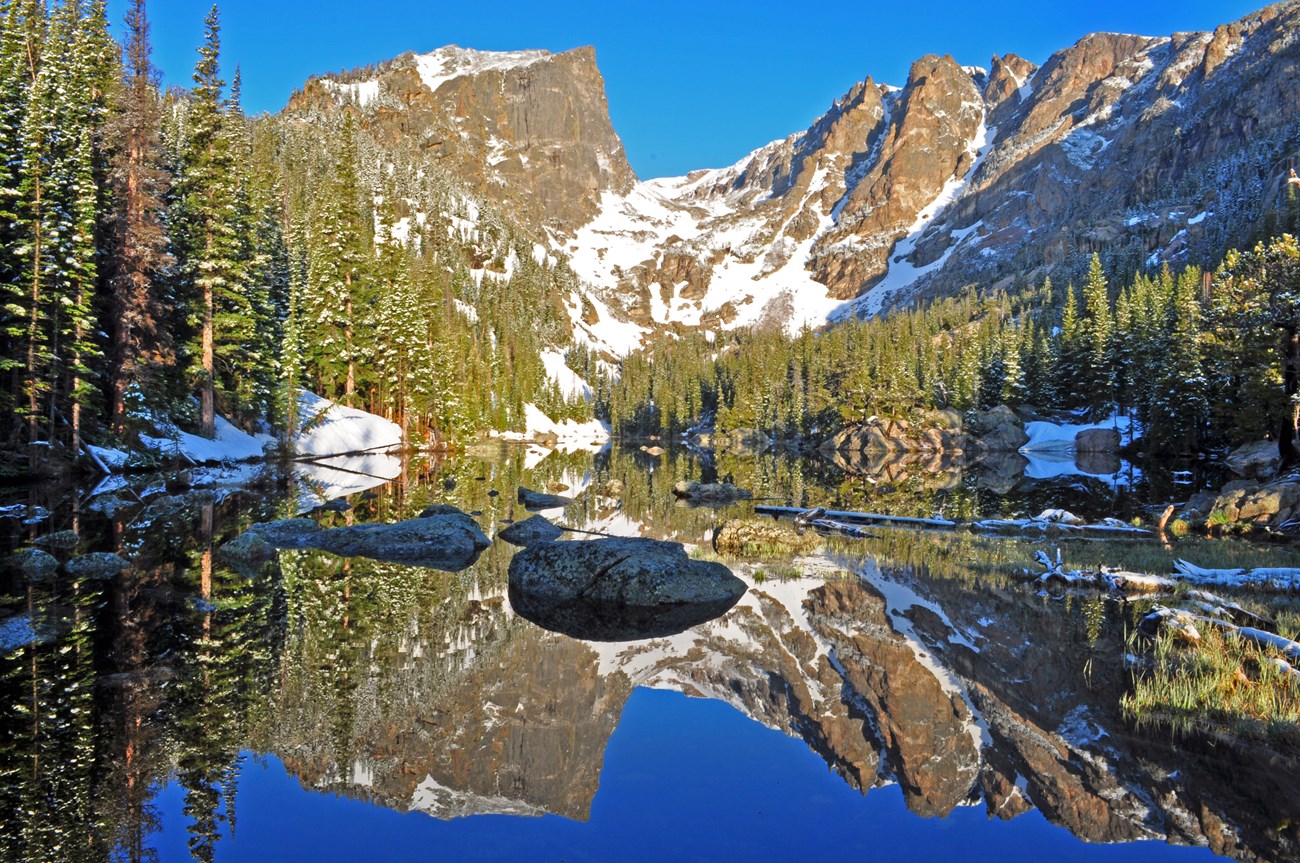 A large mountain is reflected in a crystal clear lake