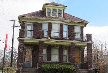 Exterior image of two story house with gabled roof.