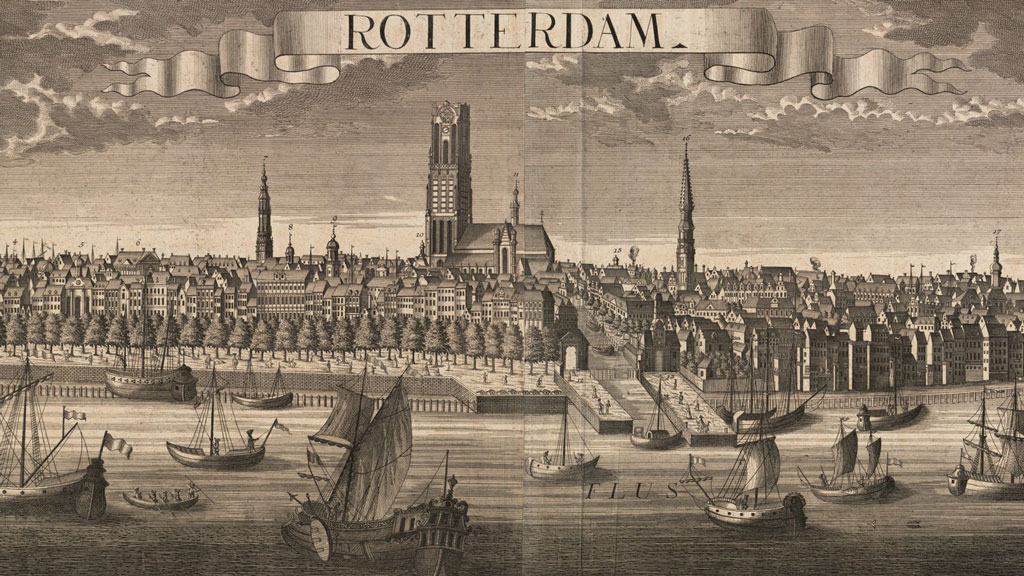 Black and white print from an engraving depicting a number of differently rigged sailing ships in a river. In background is a town with many small buildings and a few steeples pointing into the sky. In center is one larger cathedral with a square gothic style bell tower rather than a steeple. on a ribbon in the sky at the center reads "Rotterdam".