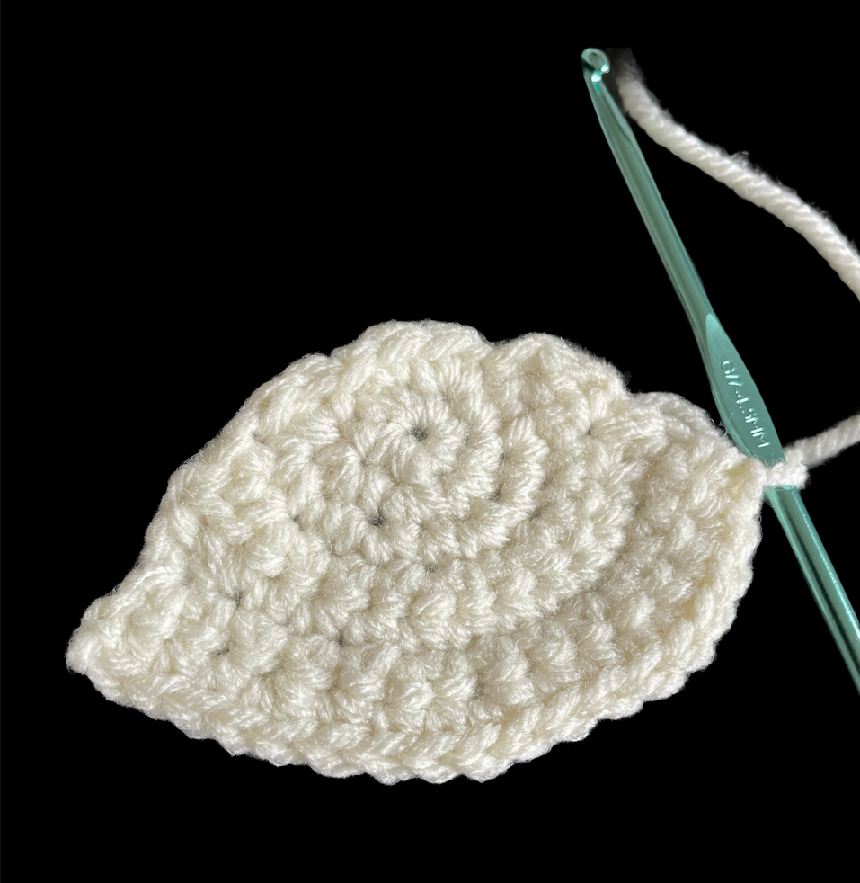 lt= White yarn that has been crocheted together to form a semi circle.